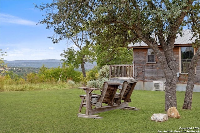 view of yard featuring a mountain view and ac unit