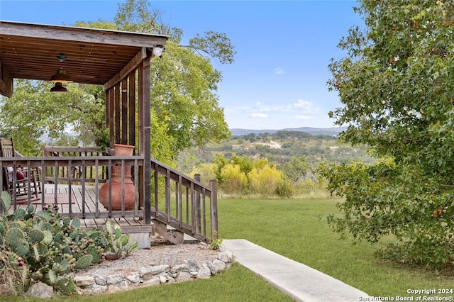 view of yard with a deck with mountain view