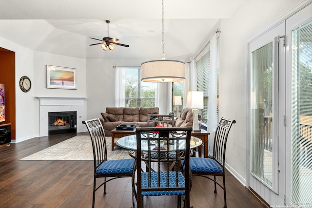 dining room with lofted ceiling, ceiling fan, a healthy amount of sunlight, and dark hardwood / wood-style floors