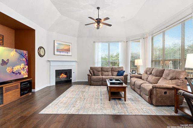 living room featuring ceiling fan, dark hardwood / wood-style flooring, and vaulted ceiling