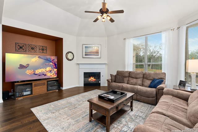 living room featuring ceiling fan, hardwood / wood-style floors, and vaulted ceiling