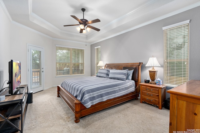 carpeted bedroom featuring a tray ceiling, access to exterior, ceiling fan, and crown molding