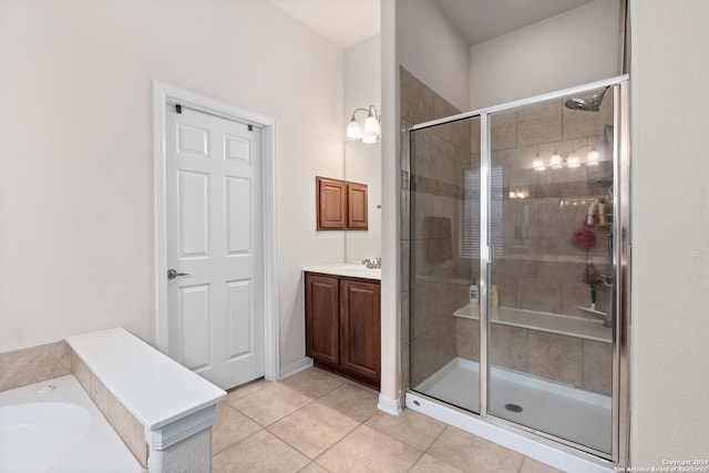 bathroom with tile patterned flooring, vanity, and a shower with door