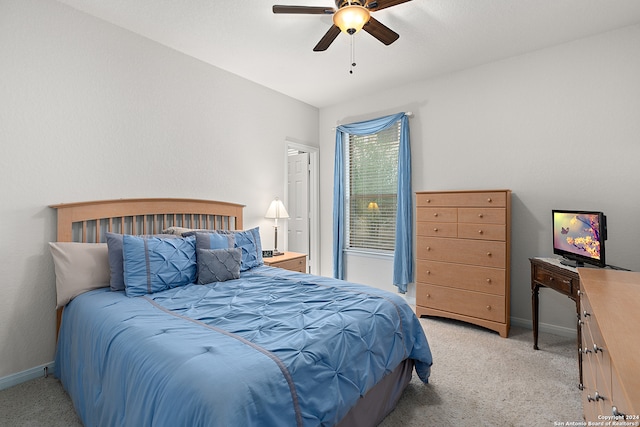 carpeted bedroom with ceiling fan and lofted ceiling