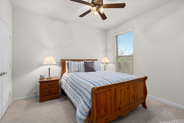 bedroom featuring ceiling fan and light colored carpet