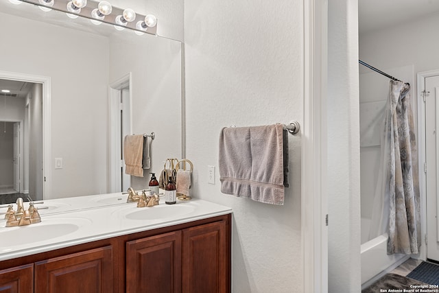 bathroom featuring vanity and shower / tub combo with curtain