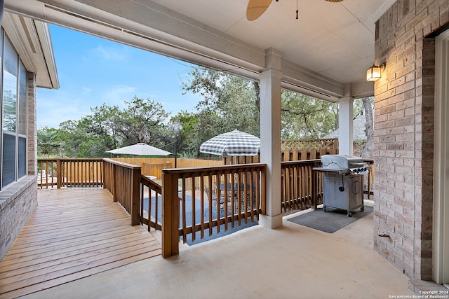 deck with grilling area and ceiling fan