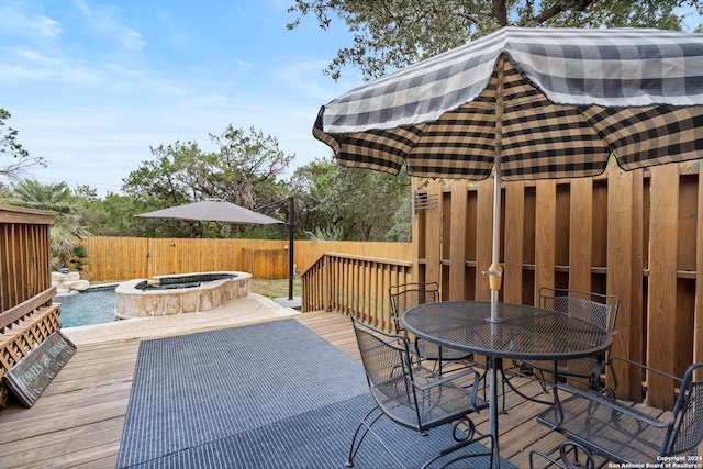 wooden deck featuring a swimming pool with hot tub