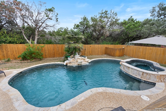 view of swimming pool with an in ground hot tub