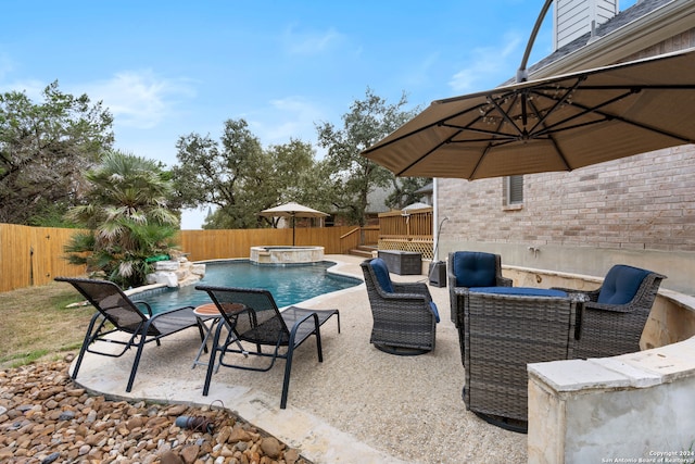 view of patio with pool water feature and a swimming pool with hot tub