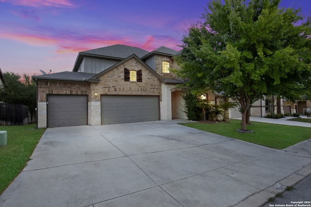 view of front of property featuring a yard and a garage