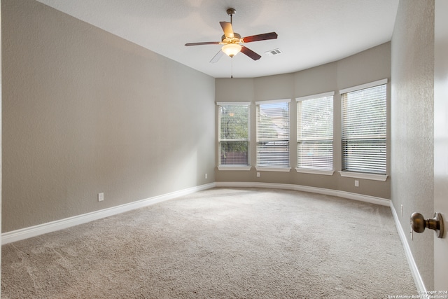 unfurnished room with carpet and ceiling fan