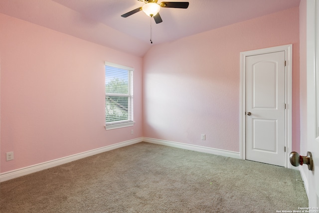 carpeted spare room featuring ceiling fan and lofted ceiling