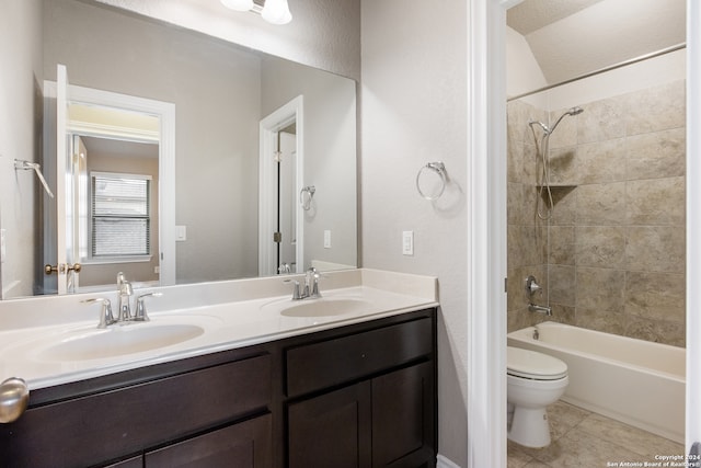 full bathroom featuring tile patterned floors, toilet, vanity, and tiled shower / bath