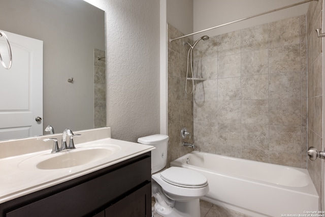 full bathroom with vanity, tiled shower / bath combo, and toilet