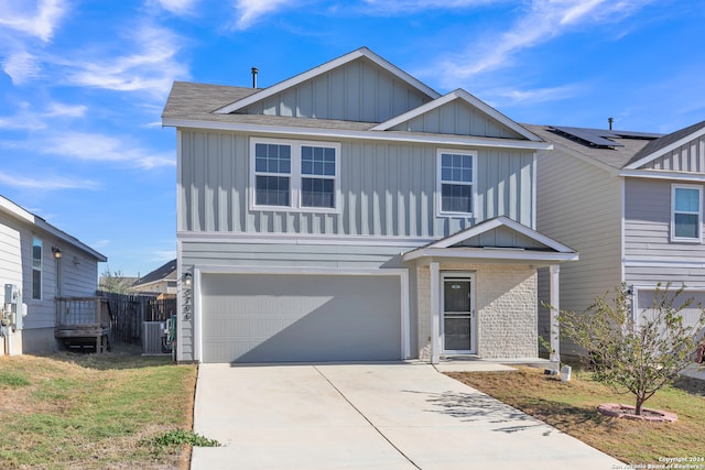 view of front of property featuring a front yard, a garage, and central AC unit