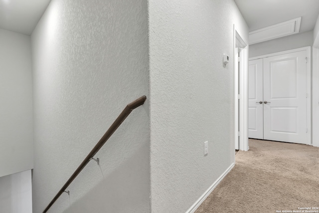 hallway featuring light carpet