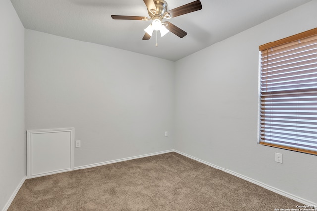 spare room featuring ceiling fan and light colored carpet