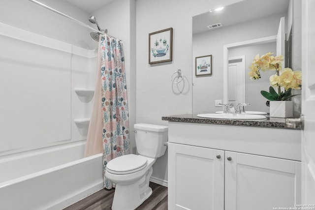 full bathroom featuring vanity, hardwood / wood-style floors, toilet, and shower / bath combo with shower curtain