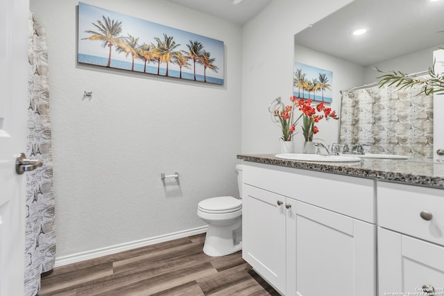 bathroom featuring hardwood / wood-style flooring, vanity, and toilet