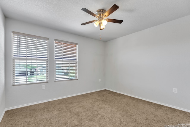 spare room featuring ceiling fan, a textured ceiling, and carpet flooring