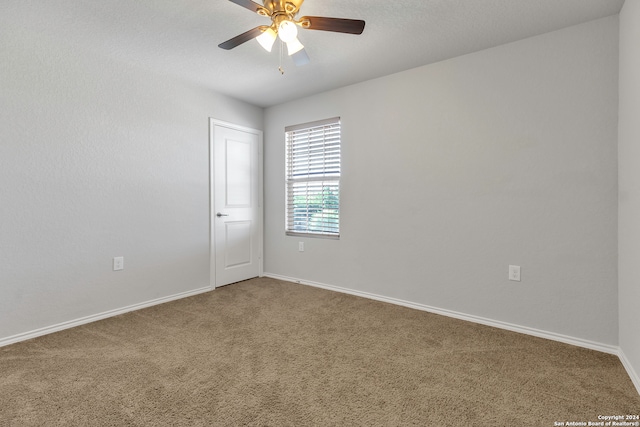 empty room with carpet flooring and ceiling fan