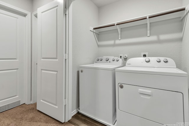 laundry area with washing machine and clothes dryer and carpet flooring