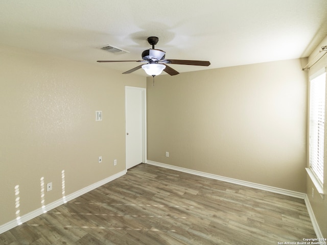 empty room featuring wood-type flooring and ceiling fan