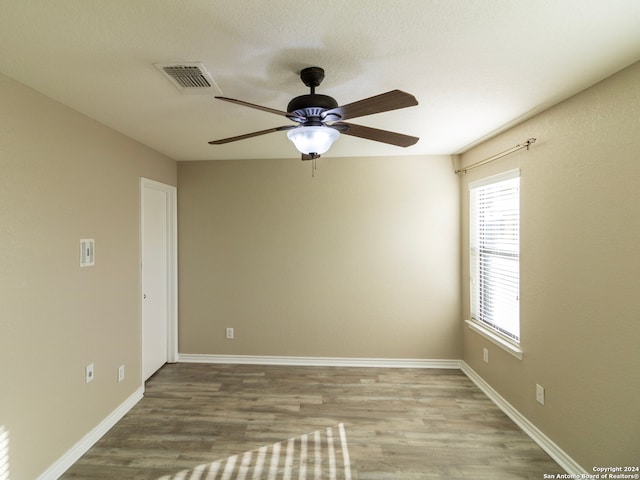 empty room featuring light hardwood / wood-style flooring and ceiling fan