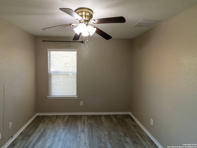 spare room featuring dark hardwood / wood-style floors and ceiling fan