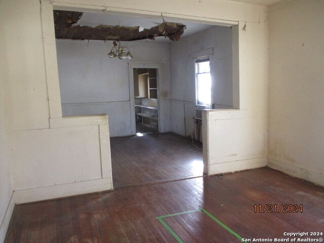 empty room with dark hardwood / wood-style flooring