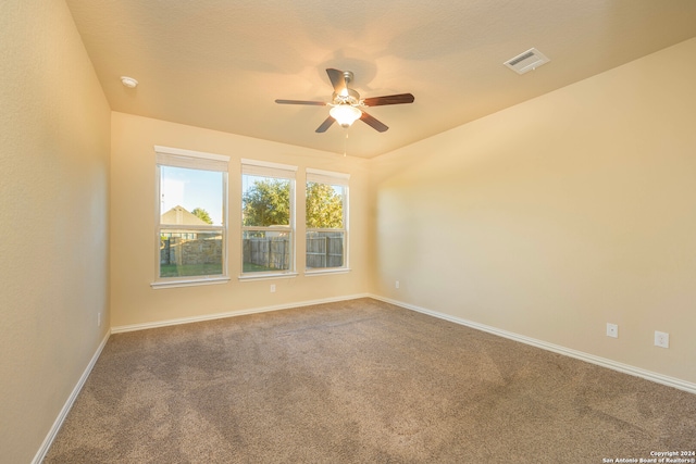 carpeted spare room featuring ceiling fan and a textured ceiling