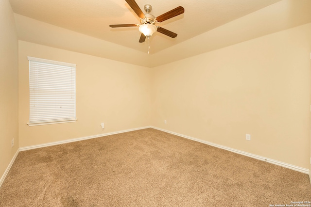 unfurnished room with ceiling fan and carpet