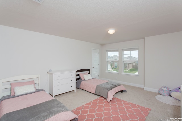 carpeted bedroom with a textured ceiling