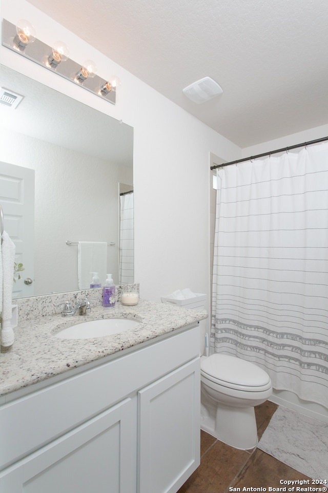 bathroom featuring tile patterned floors, a shower with curtain, vanity, and toilet