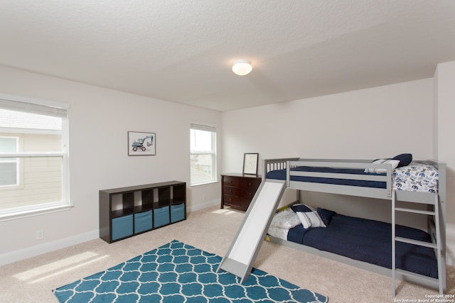 bedroom with carpet flooring and a textured ceiling