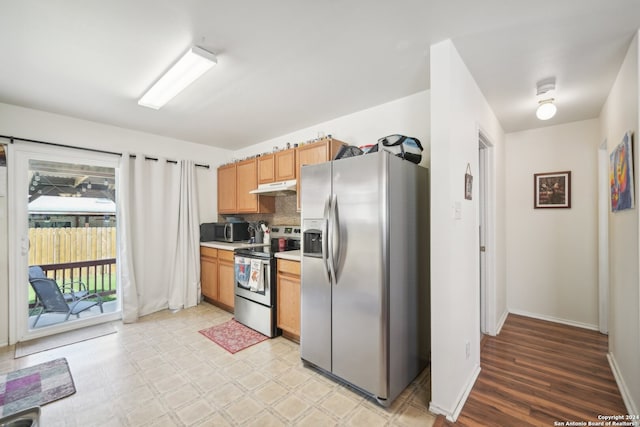 kitchen featuring appliances with stainless steel finishes, tasteful backsplash, and light hardwood / wood-style flooring