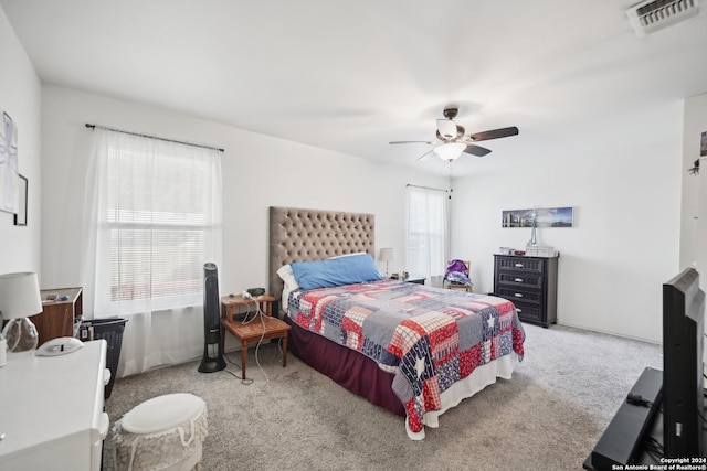 bedroom featuring ceiling fan and light carpet