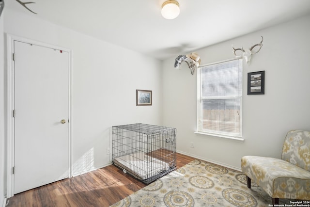 bedroom with dark hardwood / wood-style floors