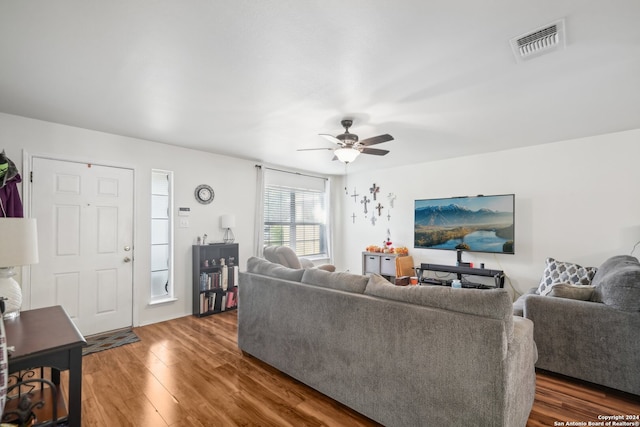 living room with dark hardwood / wood-style floors and ceiling fan