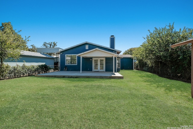 back of house with a yard, a patio area, and french doors