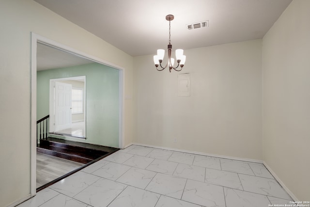 empty room with a notable chandelier