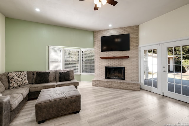 living room with ceiling fan, light wood-type flooring, a wealth of natural light, and french doors