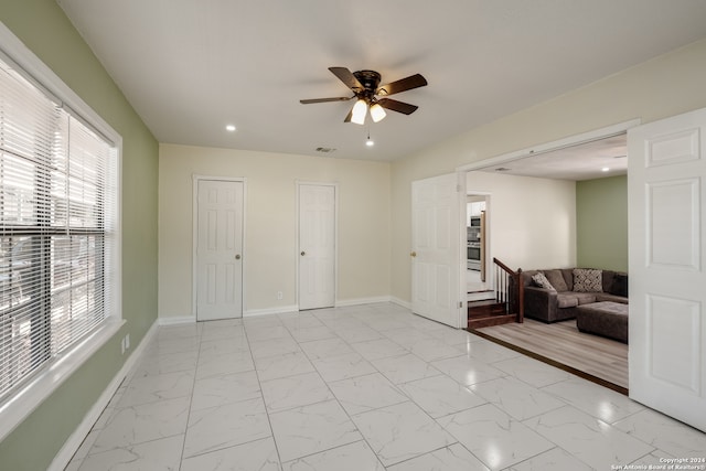 interior space with ceiling fan