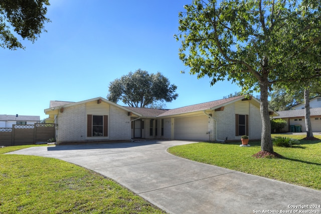 ranch-style home featuring a garage and a front lawn