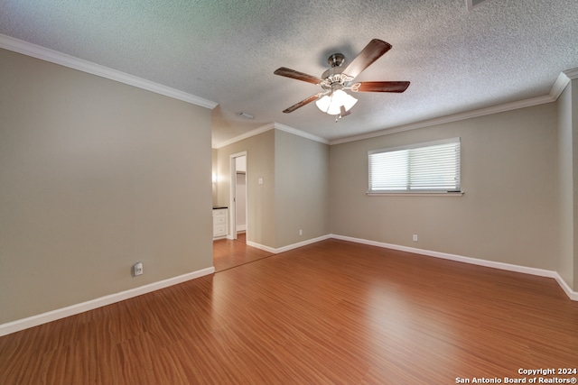 spare room with crown molding, ceiling fan, wood-type flooring, and a textured ceiling