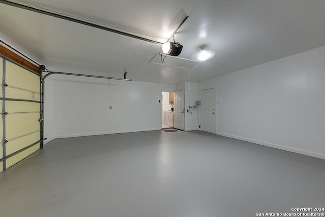 garage featuring washer and dryer and a garage door opener