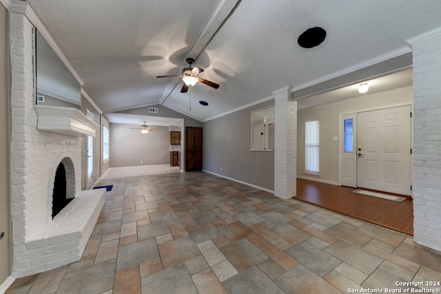 unfurnished living room featuring a fireplace, light hardwood / wood-style floors, lofted ceiling, and crown molding