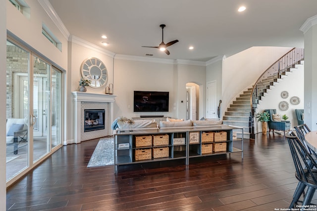 living room featuring crown molding, ceiling fan, and dark hardwood / wood-style floors