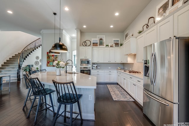 kitchen with white cabinetry, sink, dark wood-type flooring, pendant lighting, and appliances with stainless steel finishes